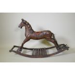 A vintage carved and painted wood rocking horse on a sleigh base, 123cm long
