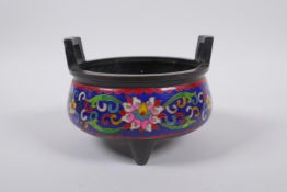 A Chinese cloisonne censer with two handles raised upon tripod supports, 15cm diameter