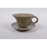 A Chinese celadon glazed porcelain Song style tea cup and saucer of petal form, 6cm high