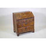 A C19th fall front bureau of small proportions, walnut veneered on a pine carcass, the drawers
