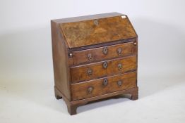 A C19th fall front bureau of small proportions, walnut veneered on a pine carcass, the drawers