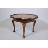 A 1930s walnut coffee table with moulded dish top and cabriole supports, 54cm diameter, 35cm high