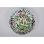 A Chinese Wucai porcelain dish decorated with figures in a landscape, Wanli 6 character mark to