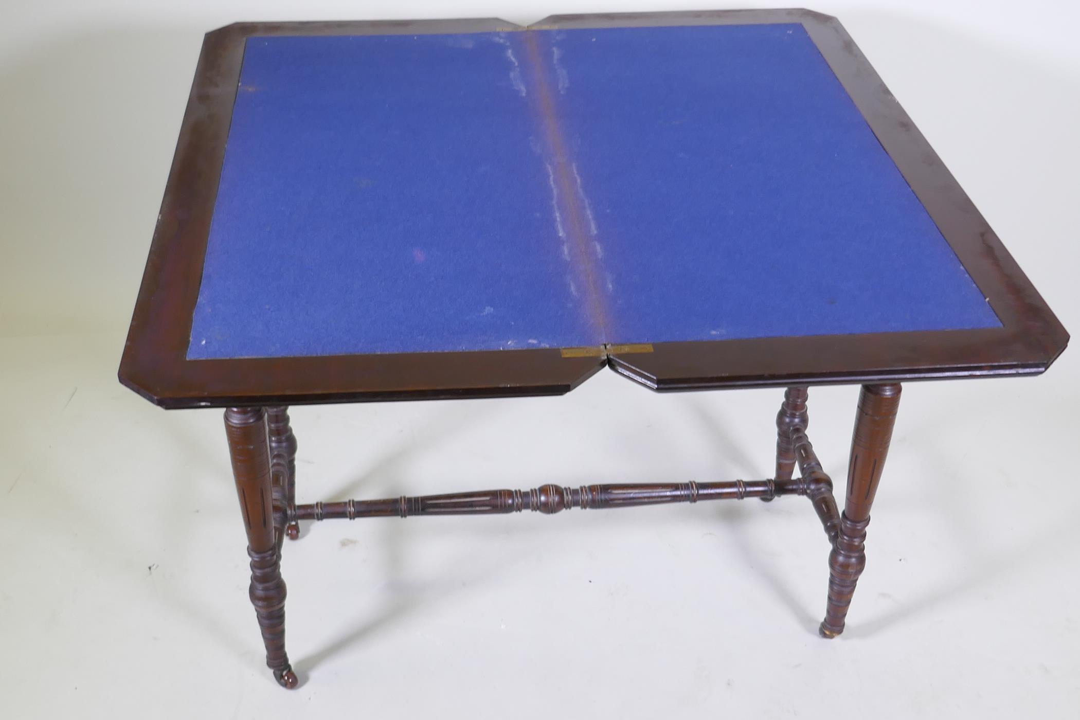 A Victorian mahogany card table, with fold out top, raised on turned supports united by a stretcher, - Image 4 of 4