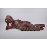 An antique Burmese carved and lacquered wood reclining figure of Buddha, 78cm long