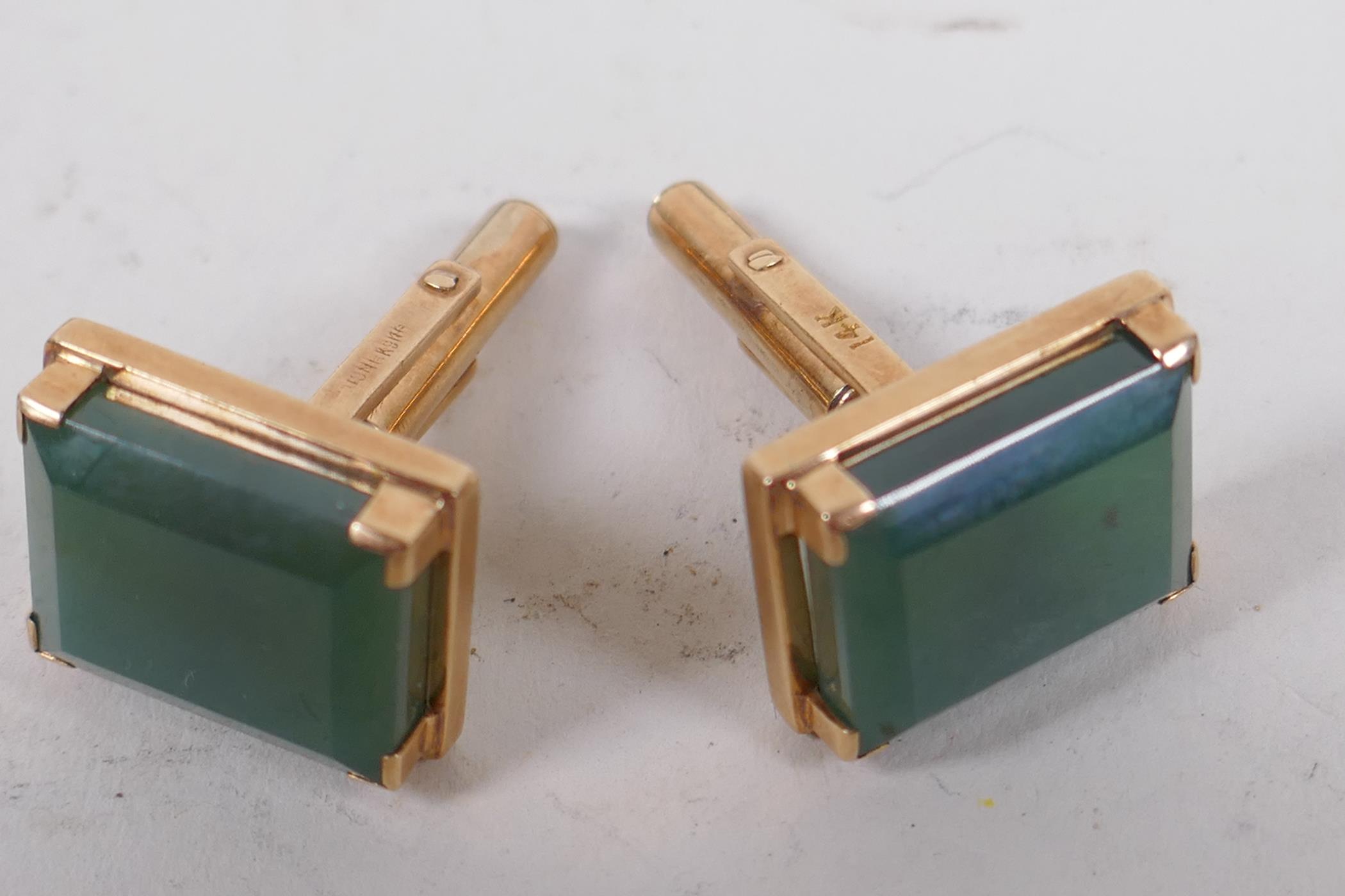 A pair of gold and green stone cufflinks, marked 14k, gross 12.1g