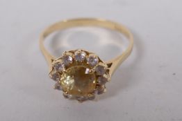 A 14ct gold dress ring set with central yellow sapphire surrounded by diamonds, size N/O