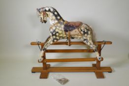An early C20th Collinson and Son's dappled grey, painted pine rocking horse, 107cm long, 87cm high