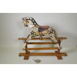 An early C20th Collinson and Son's dappled grey, painted pine rocking horse, 107cm long, 87cm high