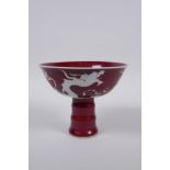 A Chinese deep red glaze porcelain stem bowl with dragon decoration and ribbed stem, star crack to