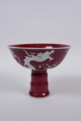 A Chinese deep red glaze porcelain stem bowl with dragon decoration and ribbed stem, star crack to