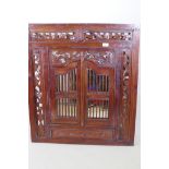 A carved wood framed mirror with pierced decoration and ornamental shutter doors, 80 x 90cm overall