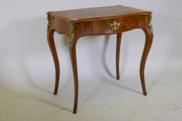 A C19th burr walnut single drawer side table, with serpentine shaped top and brass mounts, raised on