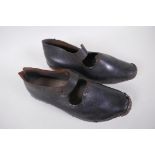 A pair of antique leather and wood dancing clogs, 26cm long