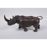 A filled bronze rhinoceros, 23cm long