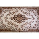 A Belgian beige ground wool carpet with a floral medallion design, 190 x 280cm