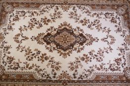 A Belgian beige ground wool carpet with a floral medallion design, 190 x 280cm