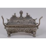A Chinese sarcophagus shaped cast white metal censer and cover, with raised dragon decoration,