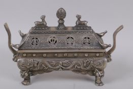 A Chinese sarcophagus shaped cast white metal censer and cover, with raised dragon decoration,
