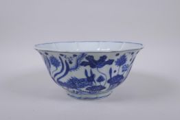A blue and white porcelain bowl with lobed rim and decoration with carp in a lotus pond, Chinese