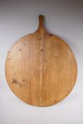 A C19th French wood bread platter/board, 65cm diameter