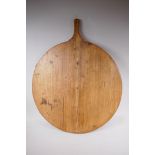 A C19th French wood bread platter/board, 65cm diameter