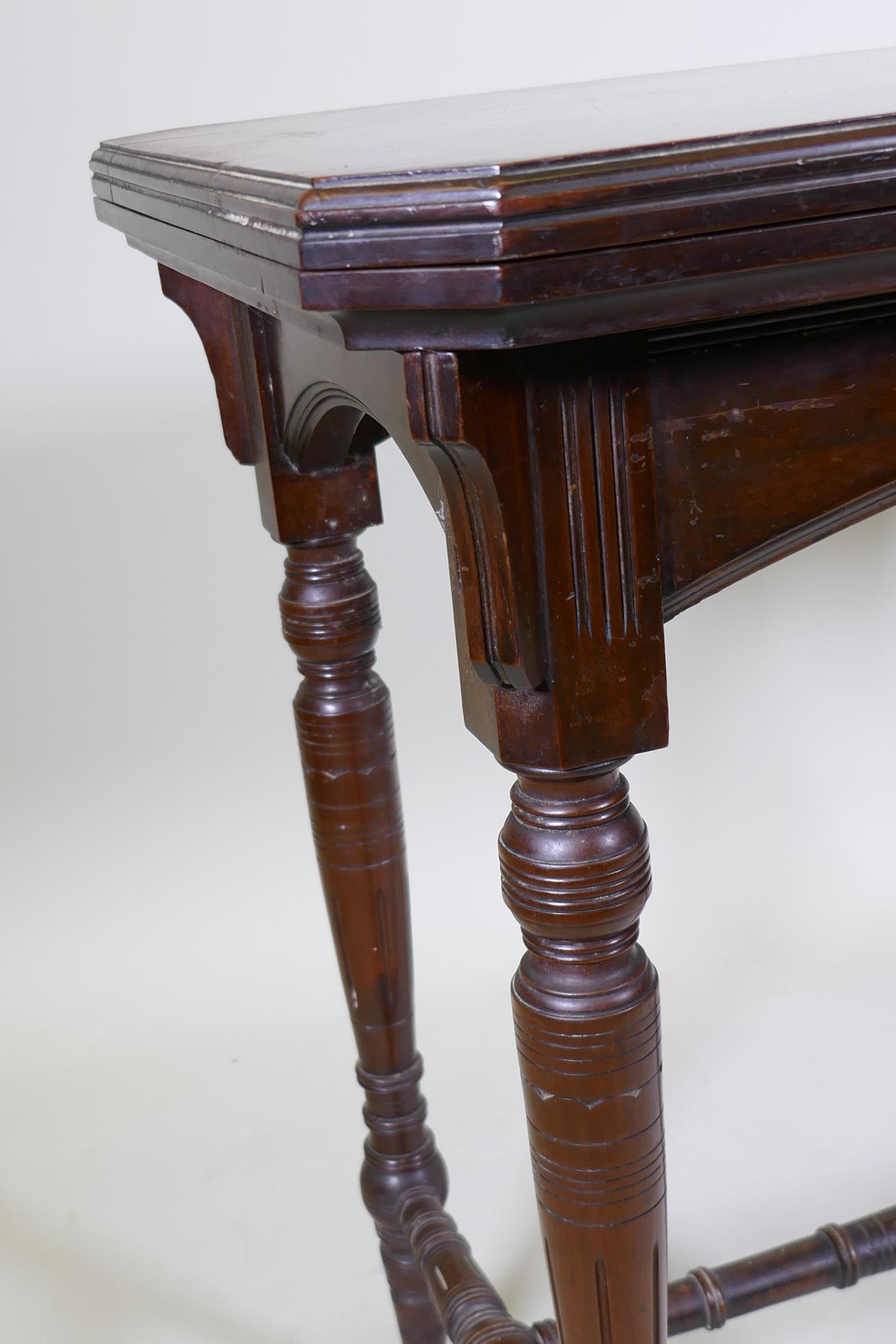 A Victorian mahogany card table, with fold out top, raised on turned supports united by a stretcher, - Image 3 of 4