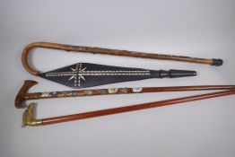 A hiking stick with carved eagle handle and metal plaques to the shaft, 93cm long, and another