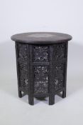 A C19th Anglo Indian occasional table with carved scrolling decoration and inset top with brass vine