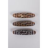 Three Tibetan agate Dzi beads, 6cm long