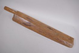 A Swedish carved pine beater, 74cm long