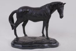 A bronze model of a horse on a marble base, 23cm high