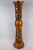 An Oriental bronze table lamp base with pierced leaf decoration, on a wooden base, 55cm high