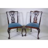 A pair of antique mahogany Chippendale style dining chairs with carved and pierced back decorated