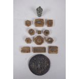 A collection of twelve antique Indian bronze jewellery moulds and two decorative bronze weights,