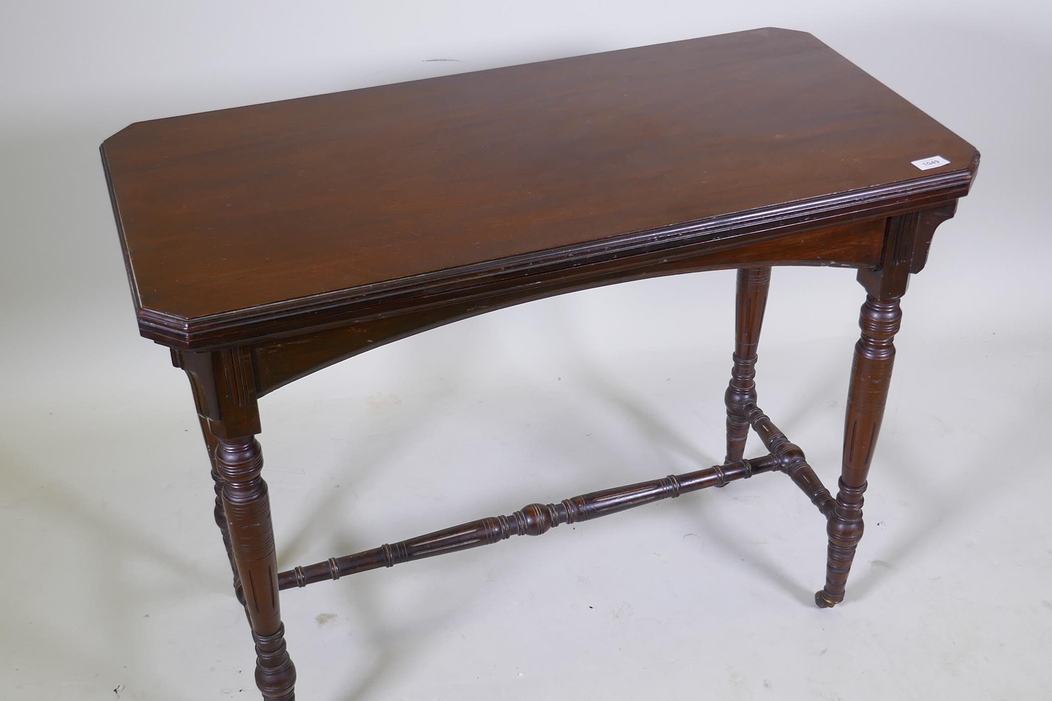 A Victorian mahogany card table, with fold out top, raised on turned supports united by a stretcher, - Image 2 of 4