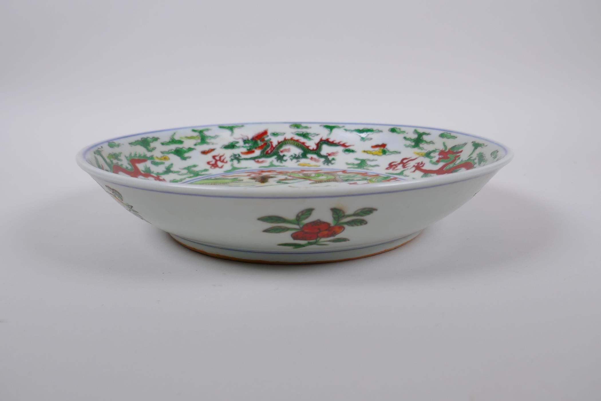 A Chinese Wucai porcelain dish decorated with figures in a landscape, Wanli 6 character mark to - Image 2 of 4