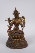A Sino Tibetan gilt bronze deity seated on a lotus throne, 21cm high