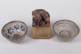 Two Japanese Meiji earthenware footed tea bowls, with painted decoration and a soapstone seal, the
