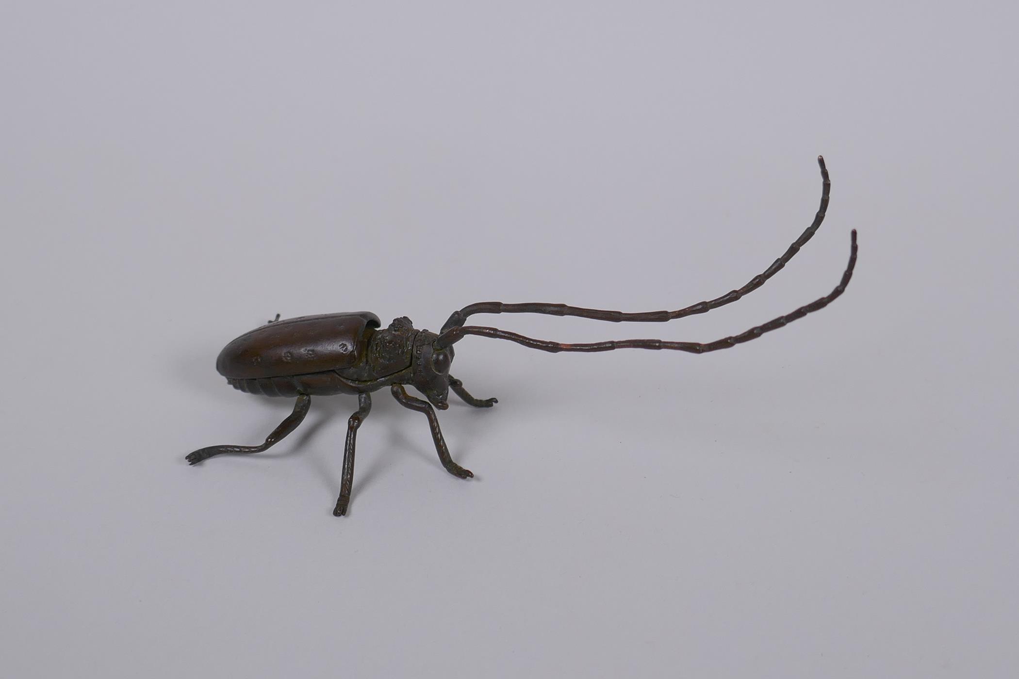 A Japanese Jizai style bronze okimono insect with articulated limbs, 12cm long