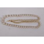 A string of graduated pearls with 9ct gold clasp, 50cm long