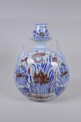 A Chinese blue and white porcelain two handled moon flask with iron red carp and lotus flower