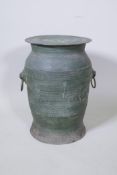 A Burmese bronze barrel shaped stool with lion mask ring handles, 50cm high, 33cm diameter