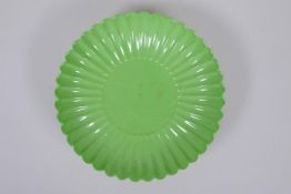 A lime green glazed porcelain petal dish, Chinese Yongzheng mark, 18cm diameter