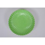 A lime green glazed porcelain petal dish, Chinese Yongzheng mark, 18cm diameter