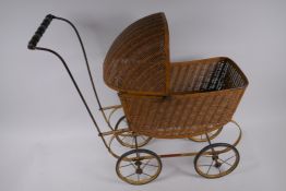 A wicker and metal doll's pram, 53cm high