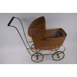 A wicker and metal doll's pram, 53cm high