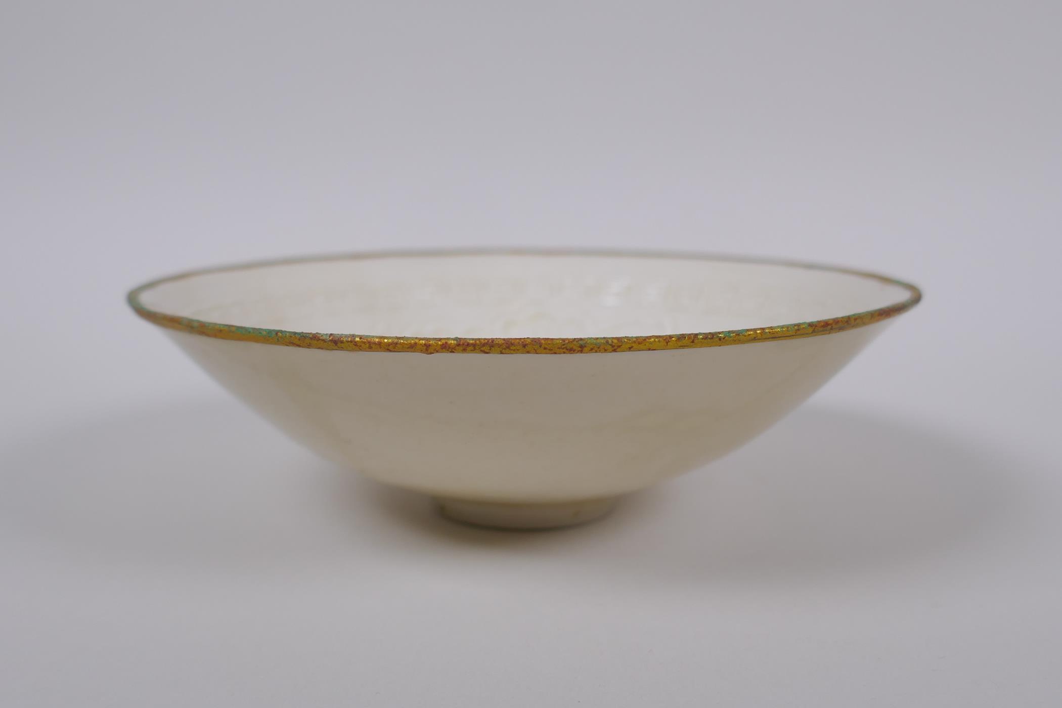 A Chinese Dingware porcelain dish with raised waterfowl decoration and a gilt metal rim, marks to - Image 2 of 3