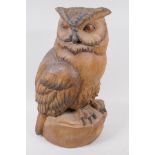 A Black Forest carved wood figure of an owl, with painted eyes, 44cm high