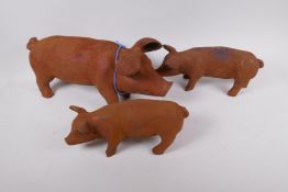 Three cast iron garden figures of a sow and two piglets, sow 44cm long